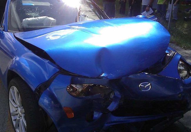 Damaged blue car for claim lawyer in Dallas