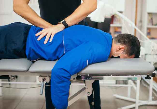 Chiropractor doing adjustment on patient
