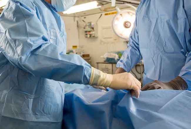 Surgeons repairing an injury