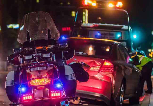 Police motorcycle in car crash scene
